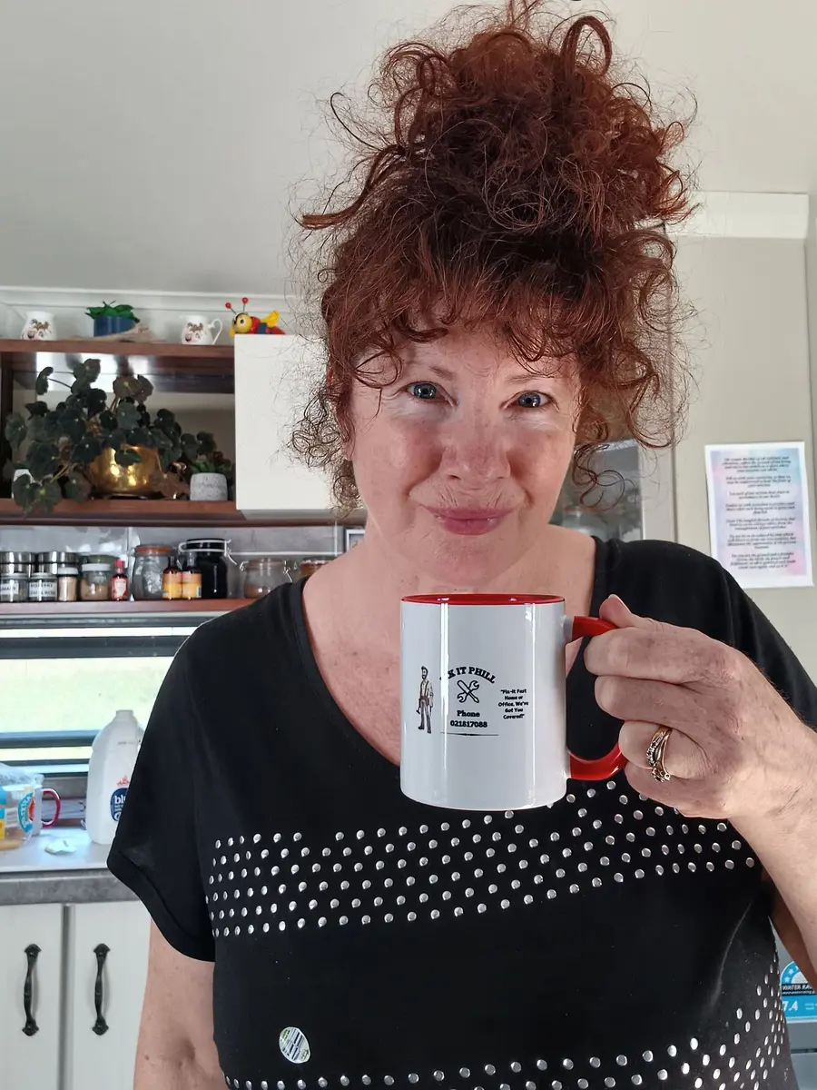 A customer holding a PPE Services mug