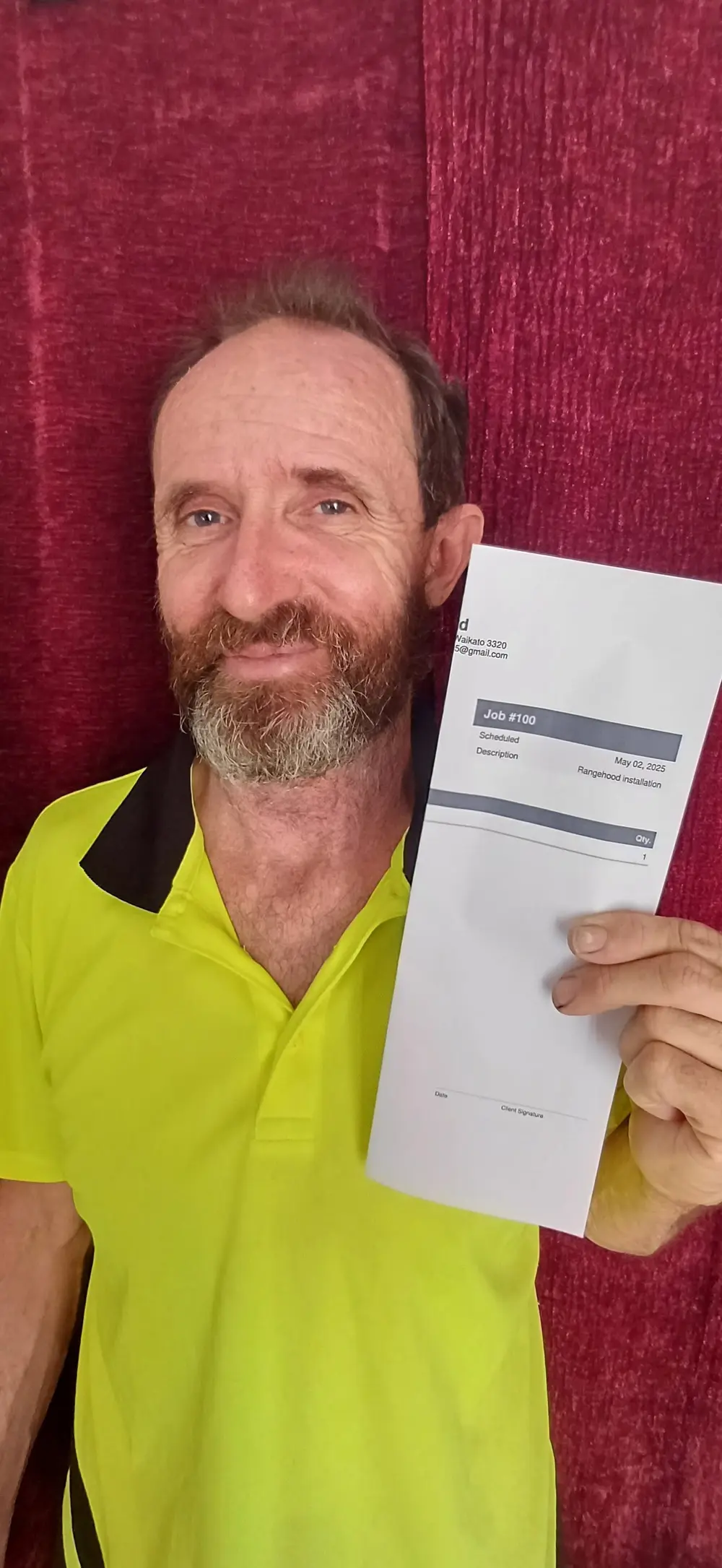Phill holding the job sheet for job number 100