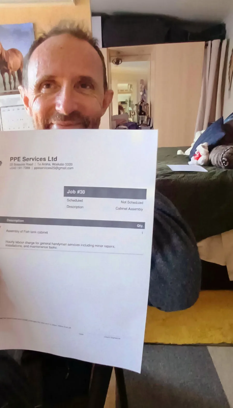 Phill holding a PPE Services job sheet