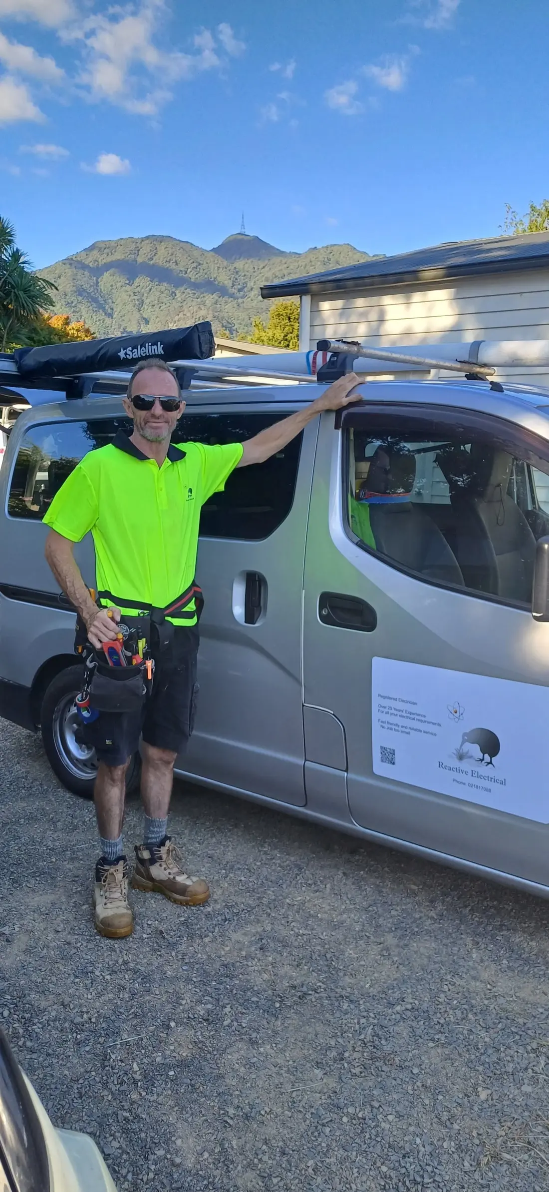 Phill Palmer beside his van with Mount Te Aroha and its summit mast behind him